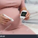 Pregnant woman monitoring blood sugar levels