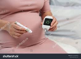 Pregnant woman monitoring blood sugar levels